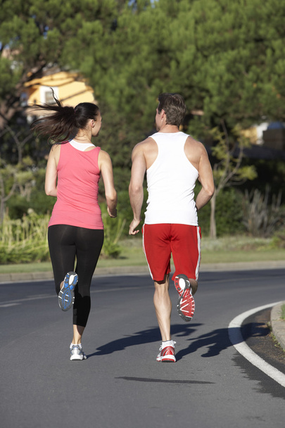 Young Couple Running On Road - Valokuva, kuva