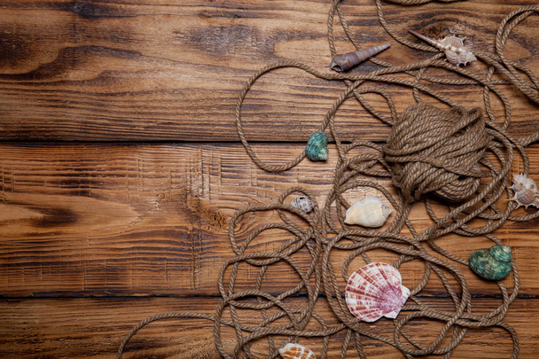 Rope and seashells on old wooden burned table or board for backg - Photo, Image