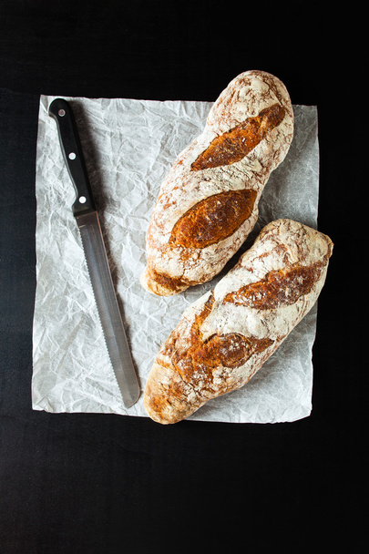 black bread and a knife for cutting bread - 写真・画像