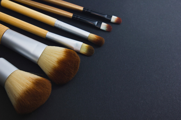 A set of brushes for professional makeup on a black background. - Photo, Image