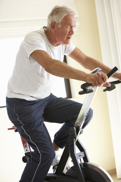 Senior Man On Exercise Bike - Фото, изображение