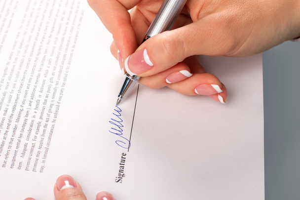 Female hand signs business letter. - Photo, Image