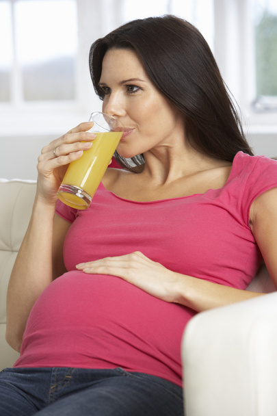 Pregnant Woman Drinking Glass Of Orange Juice  - Foto, afbeelding