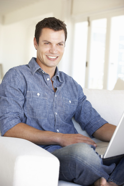 Man Using Laptop Computer At Home - Фото, изображение