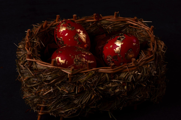Easter eggs in the nest on rustic wooden background - 写真・画像