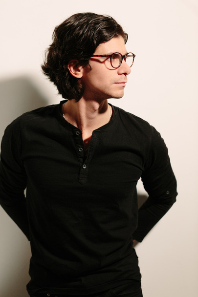 Young man in a black sweater and glasses. - Fotó, kép