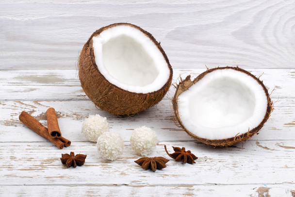 Candies, cinnamon and fresh coconut on white background - Foto, Bild