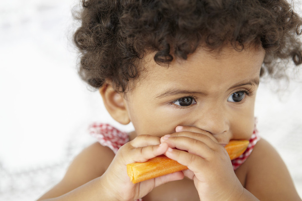 Young Girl Eating Carrot Stick - Valokuva, kuva