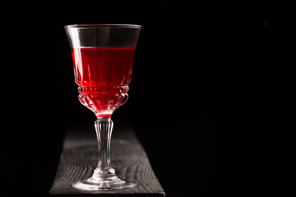Glass of red wine on a wooden table  - Φωτογραφία, εικόνα
