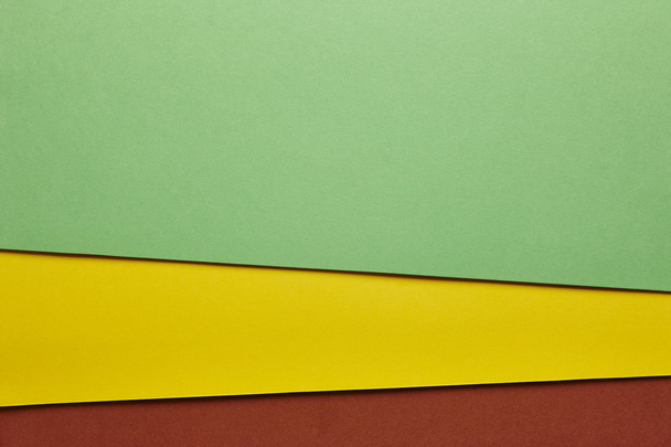 Colored cardboards background in green yellow brown tone. Copy s - Foto, Bild