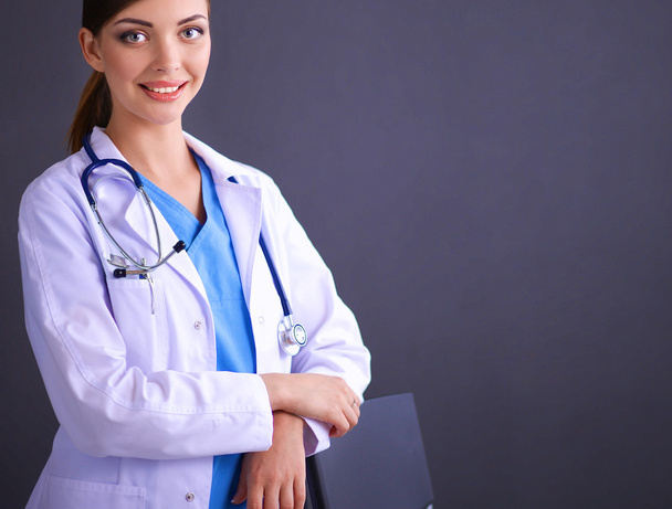 Doctor woman with stethoscope isolated on grey background - Foto, afbeelding