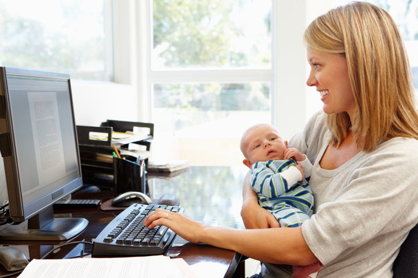 Mother working with baby in home office  - Фото, зображення