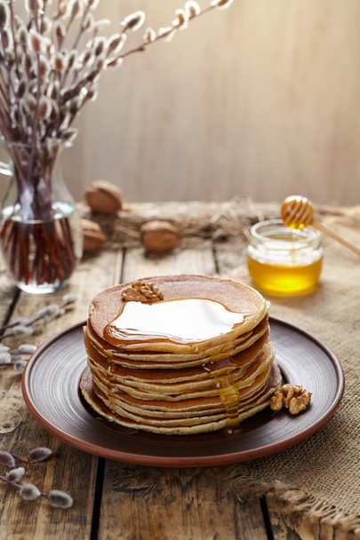Stack of traditional American pancakes with flowing honey and nuts - Φωτογραφία, εικόνα