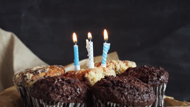 tasty birthday cupcake with candle, on grey background - Filmagem, Vídeo