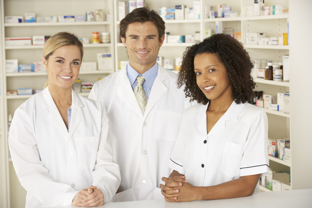 Nurse and pharmacists working in pharmacy - Foto, imagen