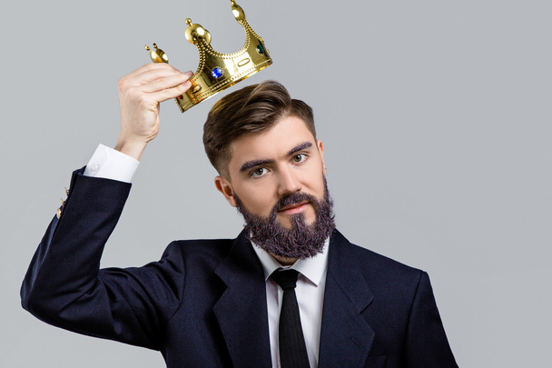 Man holding golden crown over his head - Photo, Image