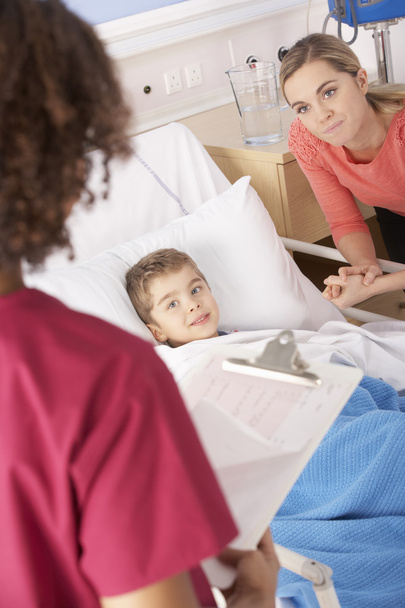 Nurse with sick boy and mother - Photo, image