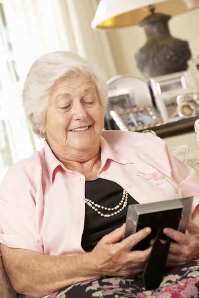 Senior Woman Looking At Photograph  - Foto, Bild