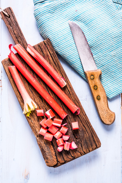 Whole and sliced steams of fresh rhubarb - Photo, Image