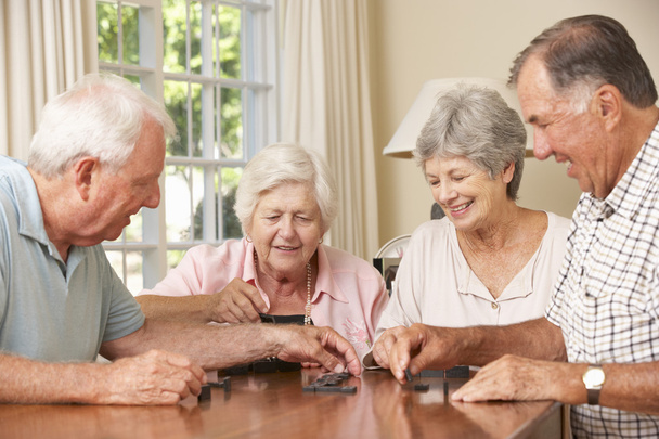 Senior Couples Enjoying Game Of Dominoes - Zdjęcie, obraz
