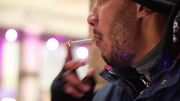 Man lighting up cigarette, smoking tobacco in public place, unhealthy habit - Filmati, video