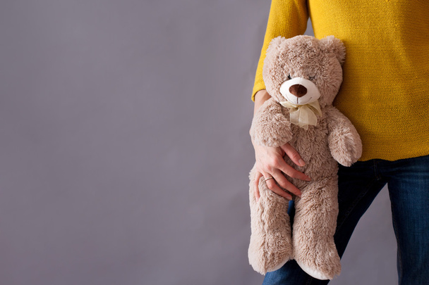 Young girl, holding sweet fluffy teddy bear - Photo, Image