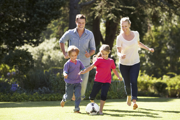 Family Playing Football In Garden  - Fotó, kép