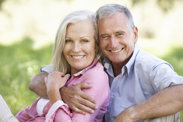 Senior Couple Relaxing In Sunny Field - Photo, Image