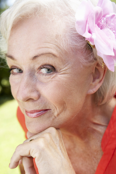 Smiling Senior Woman With Flower  - 写真・画像