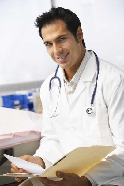 Male Doctor Reading Patient Notes - Foto, Imagen