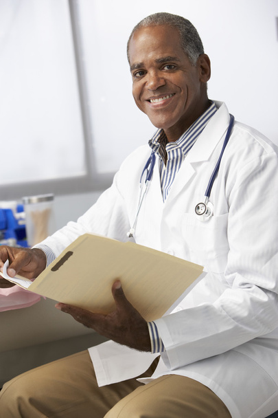 Male Doctor Reading Patient Notes - Photo, image