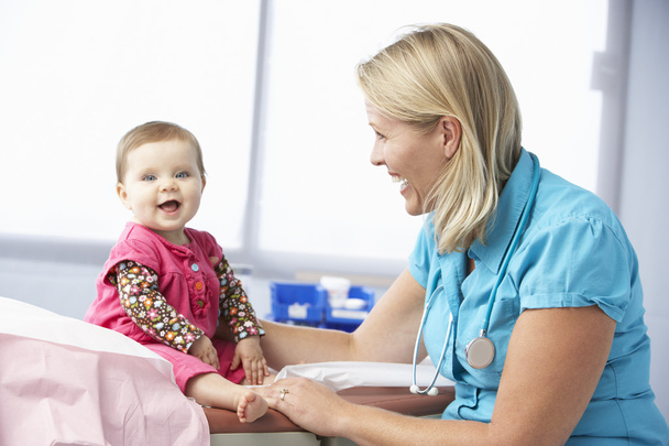 Doctor Examining Baby Girl - Фото, изображение