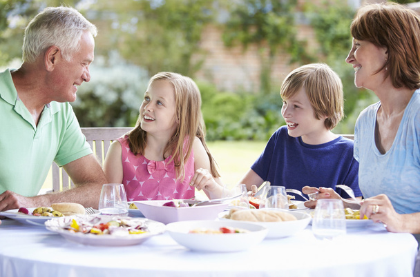 Grandparents With Grandchildren Enjoying Meal - Valokuva, kuva