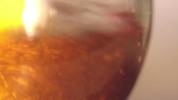 Elite light beer is being poured into a curved glass - Footage, Video