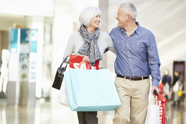 Happy Senior Couple In Shopping Mall - Photo, Image