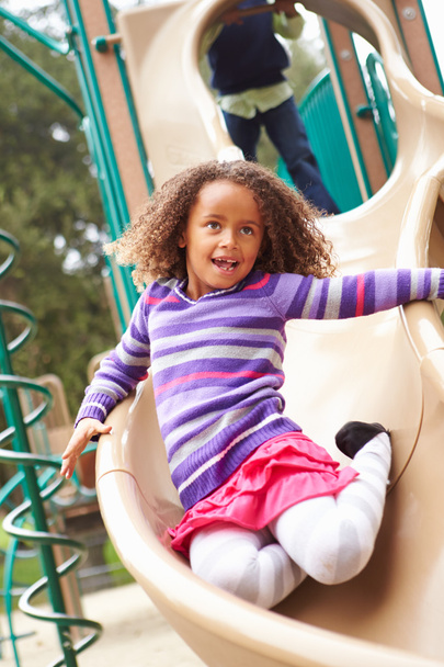 Girl Playing On Slide In Playground - Φωτογραφία, εικόνα