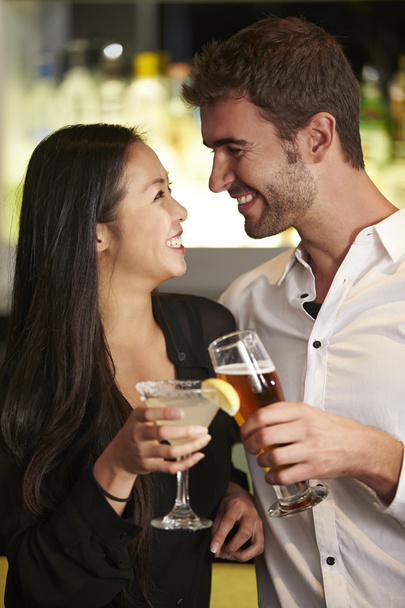 Couple Enjoying Drinks In Bar - Фото, зображення