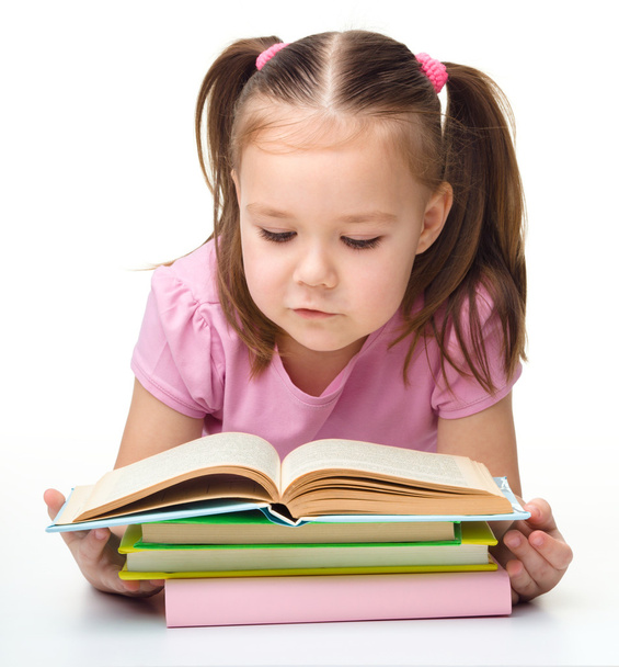 Cute little girl reads a book - Fotó, kép