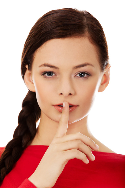 Young woman with finger on lips - Foto, immagini