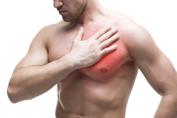 Heart attack. Young muscular man with chest pain isolated on white background - Фото, изображение