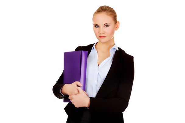 Smiling business woman holding a binder - Photo, image