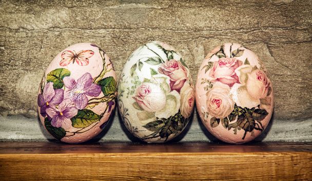 Три пасхальных яйца сложены на деревянной базе, Пасхальный праздник
 - Фото, изображение