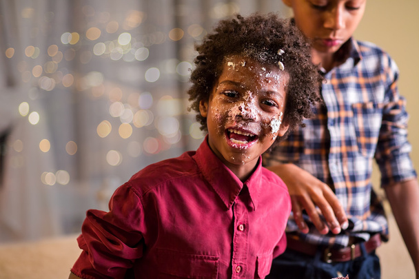 Afro gyerekek torta maszatos arcát. - Fotó, kép