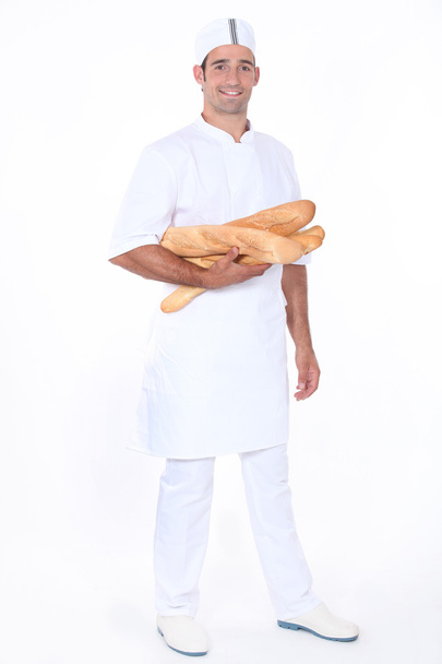 Baker with loaves of bread - Foto, immagini