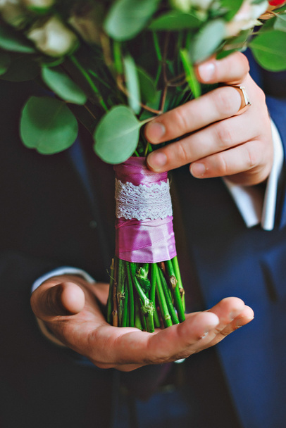groom hold wedding bouquet in his hand - Photo, Image
