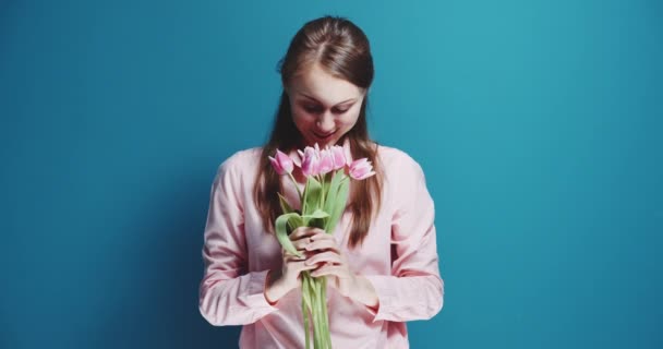 Beautiful woman with bouquet of pink tulips - Кадри, відео