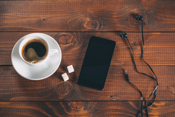 mobile phone with headphones and  cup of coffee - Foto, immagini