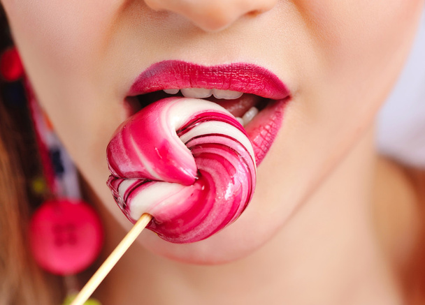 Close-up sexy red lips with lollipop - Photo, Image