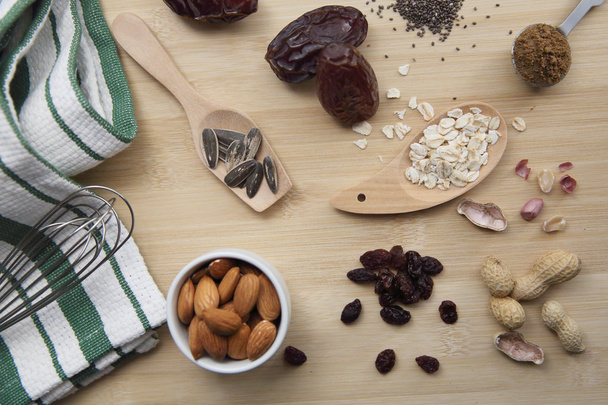 salt and nuts almond on wood background - Valokuva, kuva