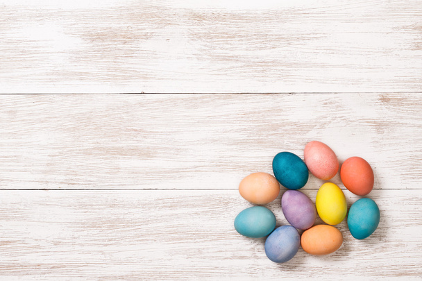 Wooden workplace with colorful eggs - Fotoğraf, Görsel
